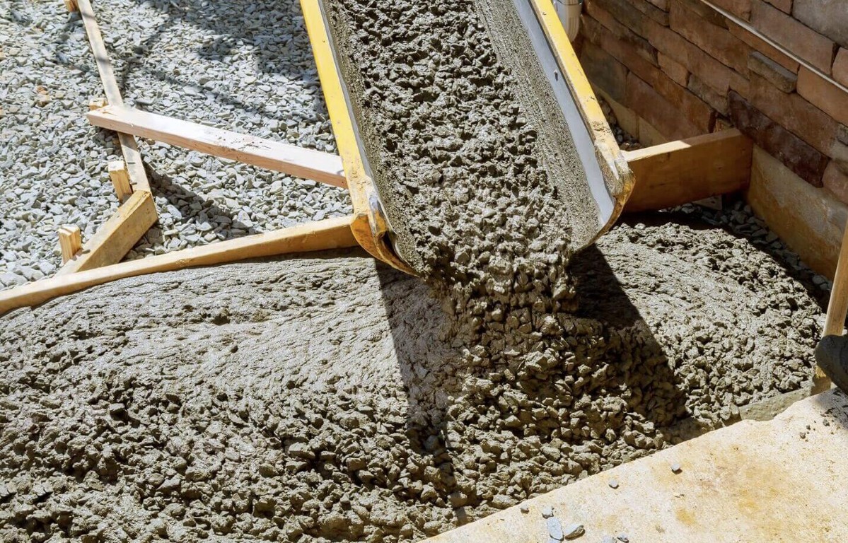 Concrete foundation repair work showing wheelbarrow pouring fresh concrete mix